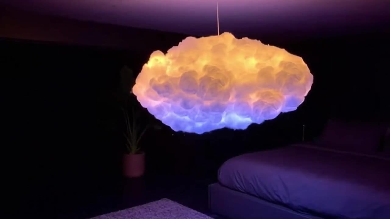 Stashly cloud lamp glowing softly in a dark bedroom